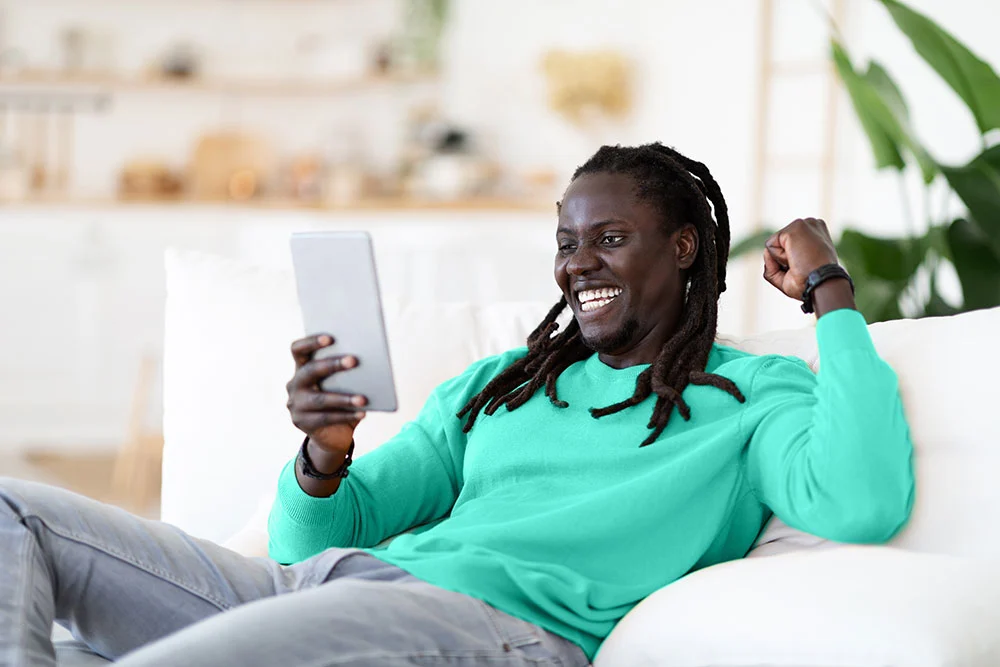 Man getting a loan from the comfort of his couch